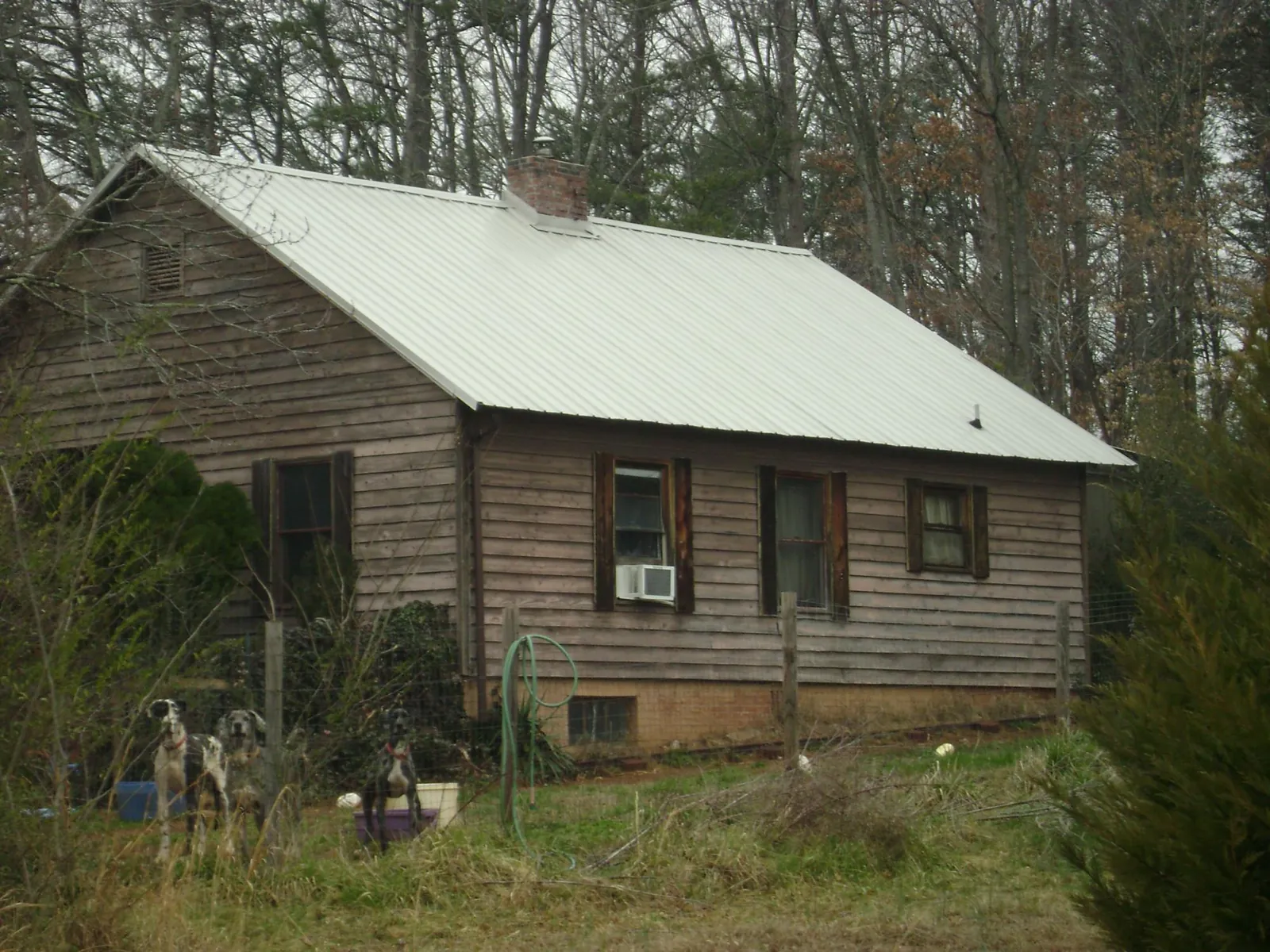 White metal roof on an old wood sided farmhouse, from a Metal Roof Installation job in Mc Queeney